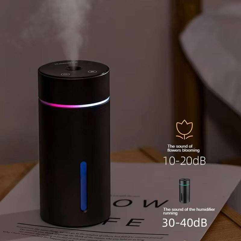 humidificador portátil para coche negro y cilíndrico, con salida de vapor, luz LED azul y aro luminoso multicolor
