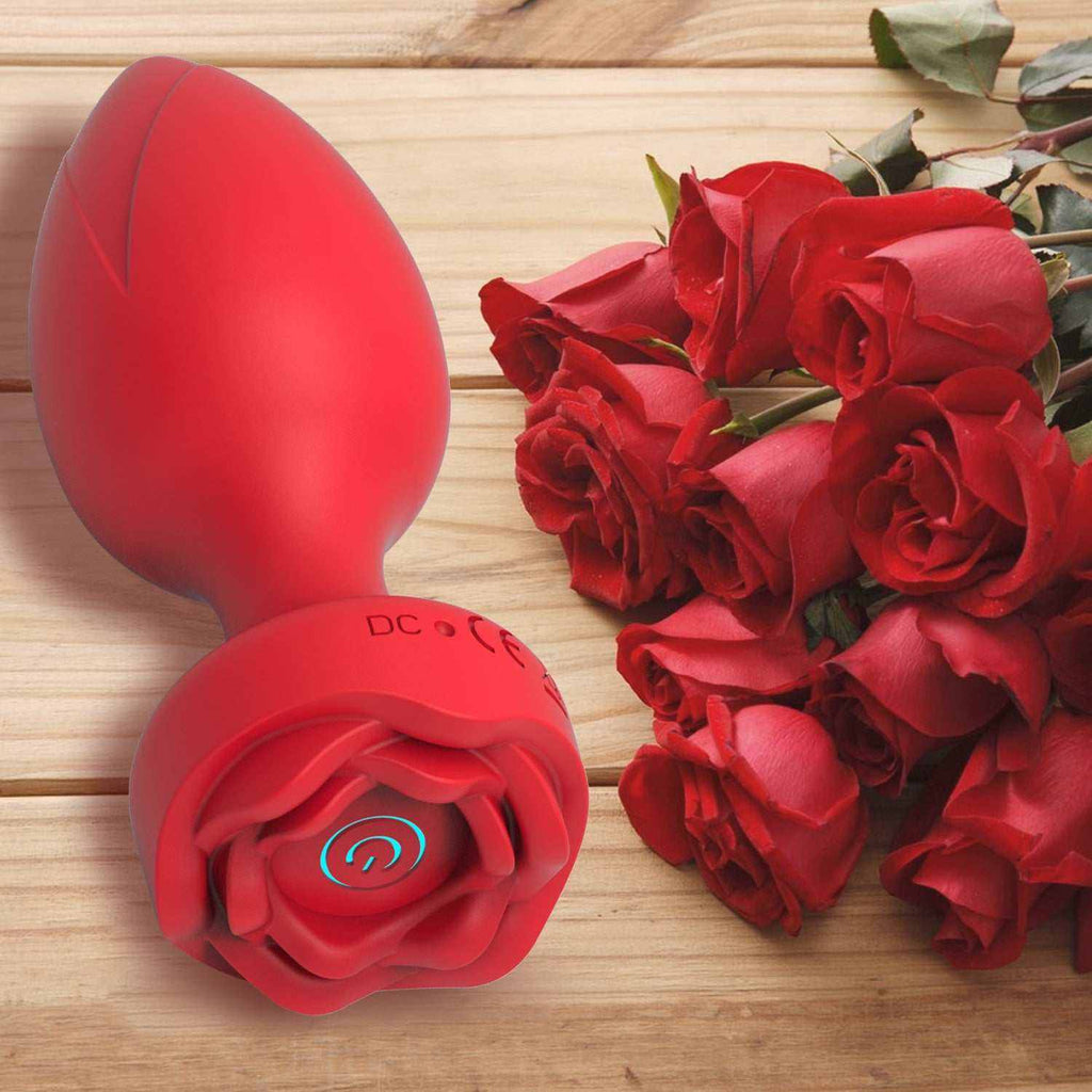 Vibrador para Mujer rojo de silicona, con diseño de rosa en la base y botón de encendido luminoso.
